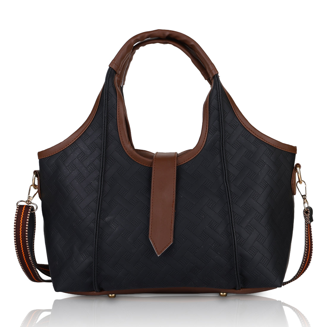 Woman holding a black handbag with brown accents against a beige wall.