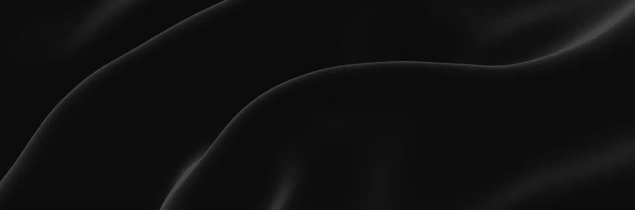 Black silk fabric with wavy folds on a black background by Ensac