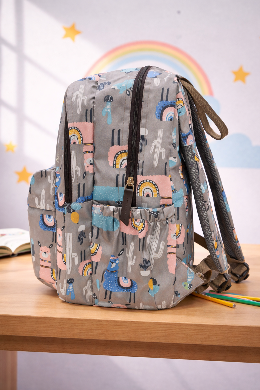 Backpack with animal pattern on a wooden surface with a rainbow and stars in the background BY ENSAC