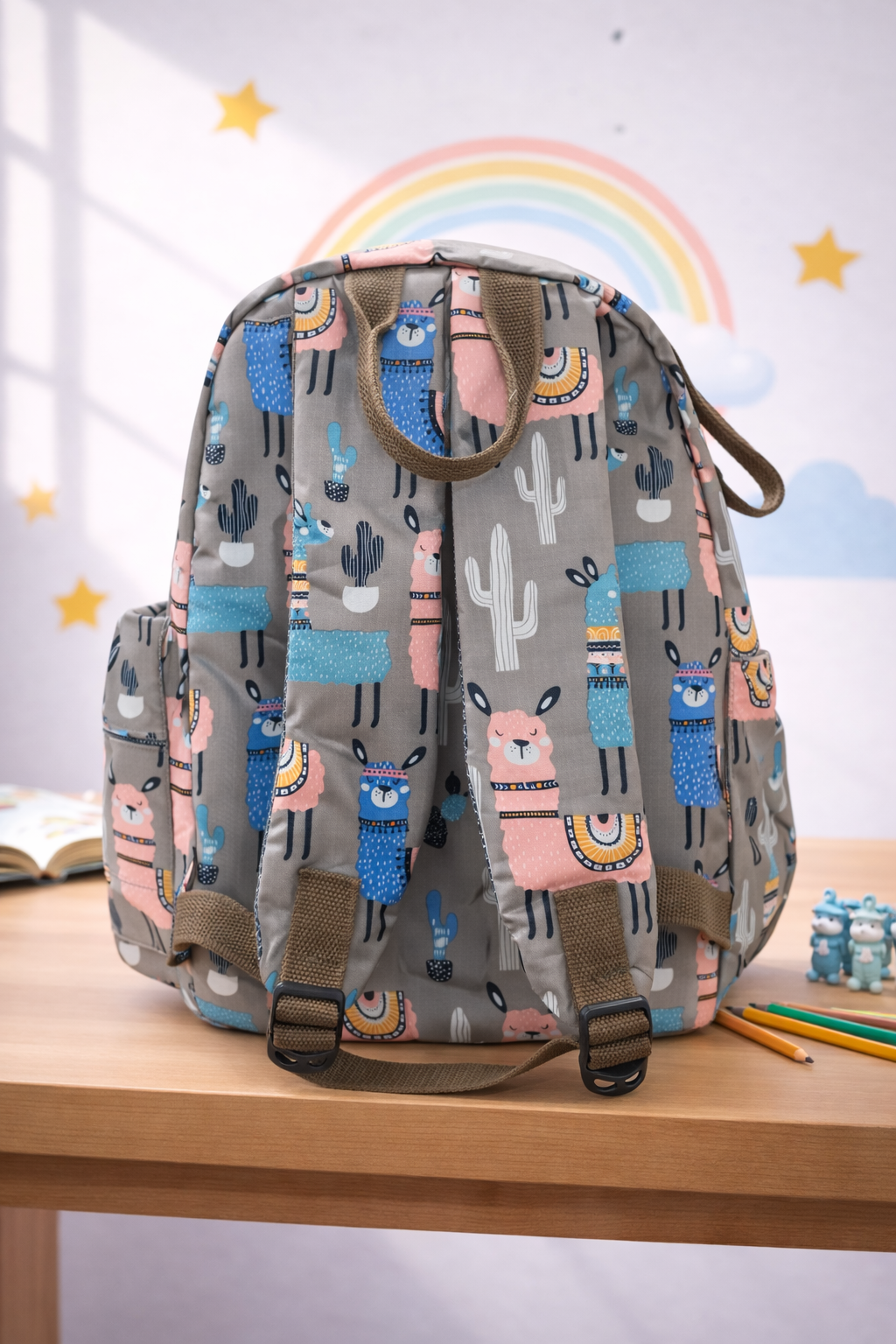 Backpack with llama pattern on a wooden surface with a colorful rainbow in the background BY ENSAC