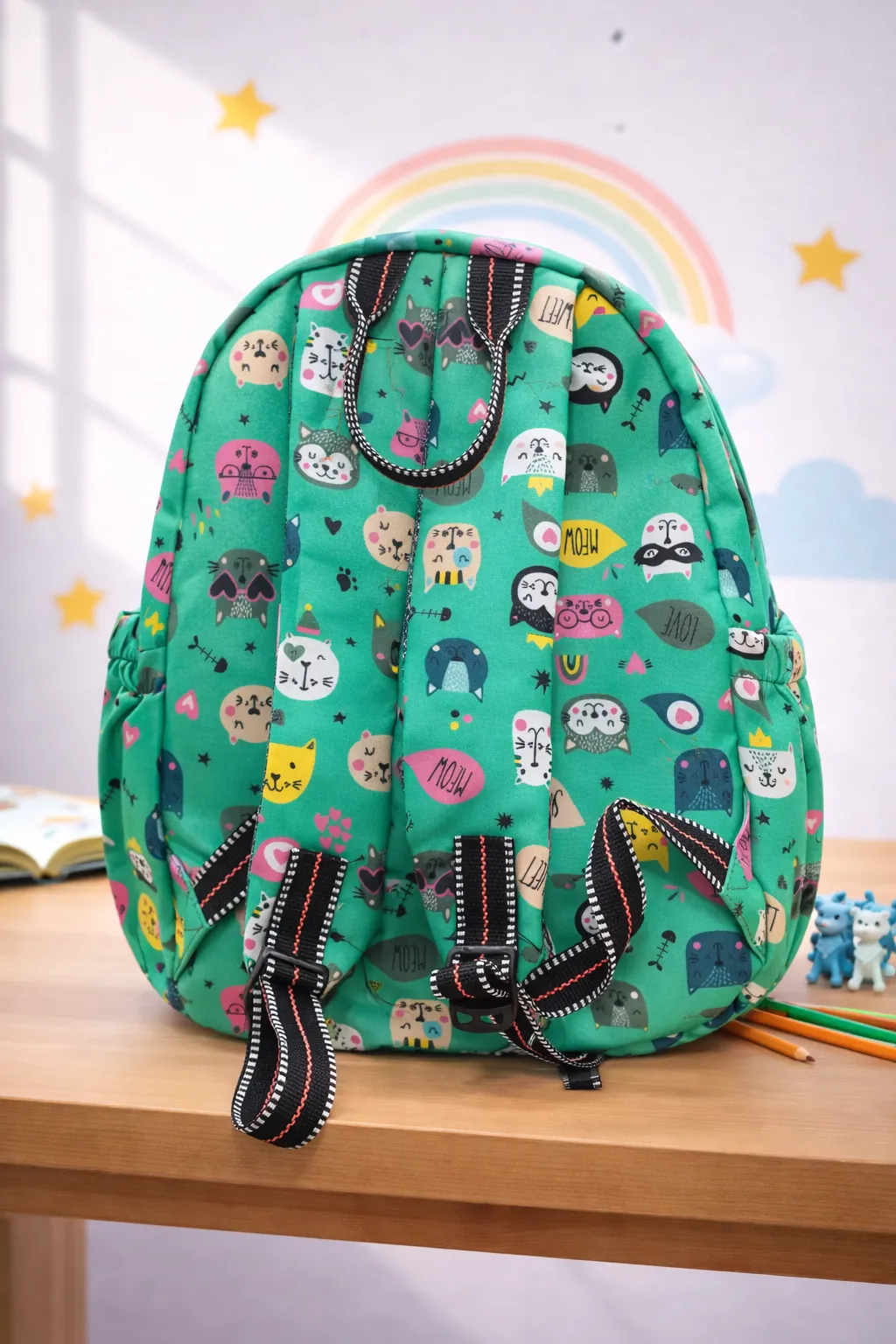 Colorful backpack with animal pattern on a wooden surface with a rainbow and stars in the background BY ENSAC