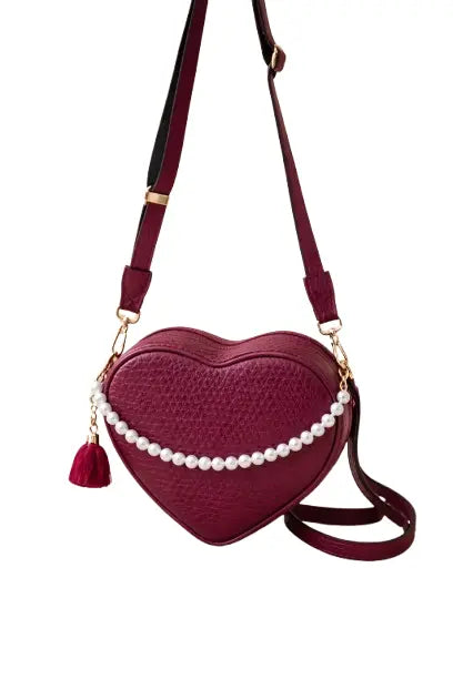 Heart-shaped handbag with pearl details on a white background BY ENSAC