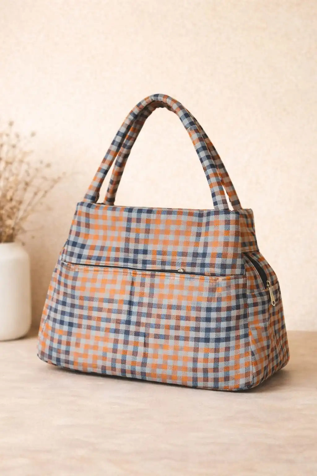 Plaid patterned handbag on a wooden surface with a neutral background BY ENSAC
